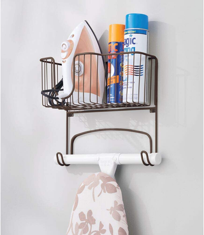 mDesign Metal Wall Mount Ironing Board Holder with Large Storage Basket - Easy Installation, Holds Iron, Board, Spray Bottles, Starch, Fabric Refresher for Laundry Rooms - Bronze